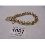 A decorative 9ct gold bracelet with ornate gold padlock and safety chain, 31.8 grams. length 20cm