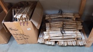 A large quantity of shabby chic/flintstones style wooden coat hangers COLLECT ONLY