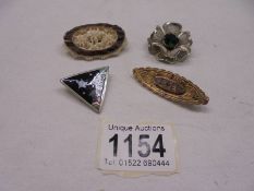 Four brooches - one in silver, one in yellow metal set with sapphire and pearls in fancy scroll work