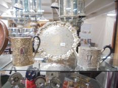 An ornate silver plate tray, teapot and hot water jug.