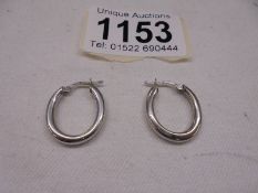 A pair of 9ct gold ear hoops,