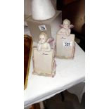 A pair of continental bisque angels menu holders
