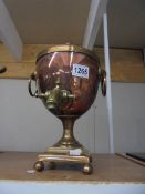 A copper samovar with brass tap.