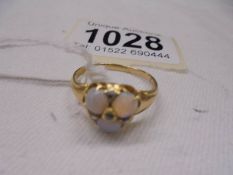 An opal and diamond set ring, tests as 18ct gold, size Q, 3.9 grams.