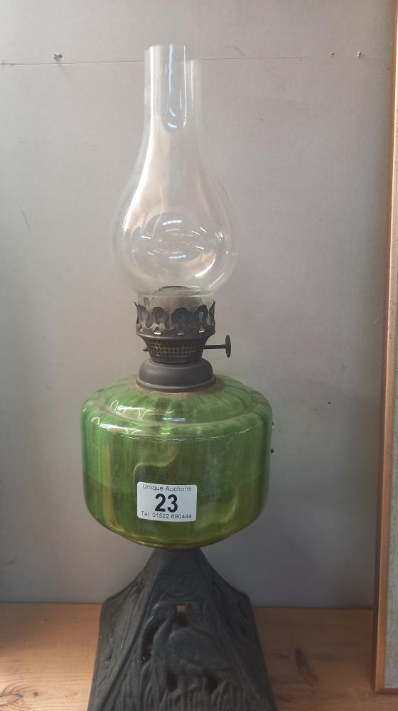 A Victorian oil lamp with green glass font and cast iron base - Image 2 of 3