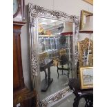 A large decorative mirror in silver coloured frame. COLLECT ONLY.