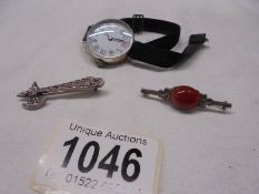 Two silver brooches and a ladies silver wrist watch.