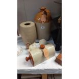A stoneware 2 gallon flagon, barrel with wooden tap and 2 foot warmers COLLECT ONLY