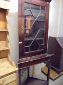 A mahogany astragal glazed corner cabinet on stand, COLLECT ONLY.