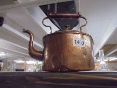 An oval copper kettle.