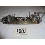A miniature four piece tea set on a silver tray, D H & S, Birmingham 1973, 65 grams.