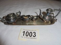 A miniature four piece tea set on a silver tray, D H & S, Birmingham 1973, 65 grams.