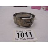 An engraved hall marked silver bangle with buckle, 50.9 grams.