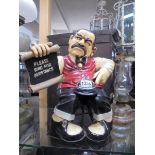 A novelty figure by Peter Mook of an angry man 'Please Ring for Assistance' shop bell. 40cm tall.