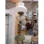 An oil oil lamp on metal base with glass font and complete with shade and chimney, COLLECT ONLY.