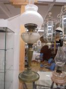 An oil oil lamp on metal base with glass font and complete with shade and chimney, COLLECT ONLY.