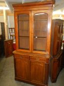 A Victorian mahogany bookcase with two doors, two drawers and glazed doors to top,. COLLECT ONLY.