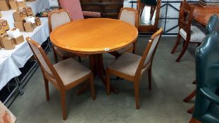 A teak dining table and four chairs. COLLECT ONLY.