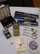 A mixed lot including silver spoons, boxed silver handled flat ware, Wedgwood brooch,