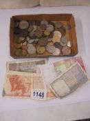 A mixed lot of foreign coins and a few bank notes.