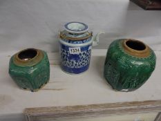Two Chinese green ceramic pots and a Chinese blue and white teapot.