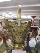 A heavily embossed brass lidded coal scuttle, COLLECT ONLY.