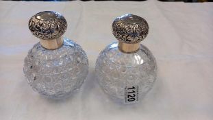 Pair of Silver topped grenade shaped glass toilet bottles, the bodies with hobnail cutting, Chester