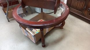 A round dark wood coffee table with glass top COLLECT ONLY