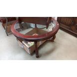 A round dark wood coffee table with glass top COLLECT ONLY