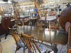 An Ercol dining table with six Ercol dining chairs, COLLECT ONLY.