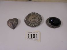 A Egyptian silver brooch and two others.