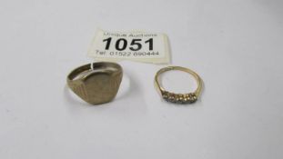 A 9ct gold signet ring, size V, 2.66 grams a/f and a gold five stone ring size 0 half, 1.23 grams.