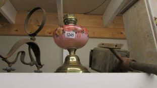 A Victorian oil lamp with pink glass font, a coach/porch lamp and a wall bracket.