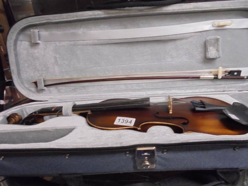 A cased violin with bow.