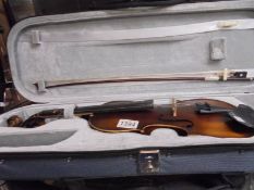 A cased violin with bow.