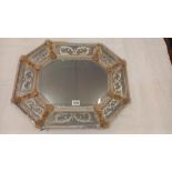 A 1920s venetian wall mirror, the elongated octagonal cushion shaped frame with gilt flower dividers