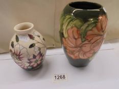 A vintage Moorcroft vase and another Moorcroft vase. smaller vase A/F with red dot