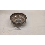 An ornate silver dish on four feet by Goldsmiths and silversmiths company, 4.5 ounces.