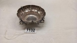 An ornate silver dish on four feet by Goldsmiths and silversmiths company, 4.5 ounces.