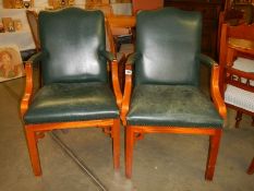 A pair of mahogany green leather arm chairs. COLLECT ONLY.