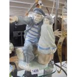 A large NAO figure of a fisherman with a child, 31cm tall. COLLECT ONLY.