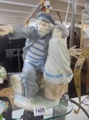 A large NAO figure of a fisherman with a child, 31cm tall. COLLECT ONLY.