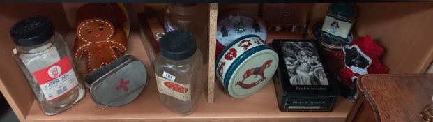 A good selection of tins, vintage sweet shop bottles/jars and a pottery gingerbread man biscuit