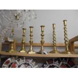 Three pairs of brass candlesticks.