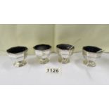 A set of four silver salts with blue glass liners with three spoons, silver weight 6.5 ounces.