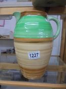 A Shelley green and brown striped jug, 25 cm tall.