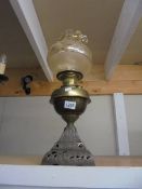 An oil lamp on metal base with brass font and later shade, COLLECT ONLY.