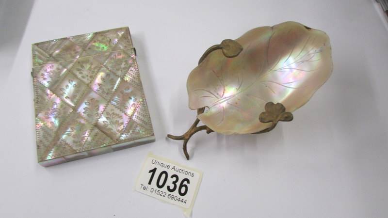 A 19th century mother of pearl card case and an art deco mother of pearl caviar dish.