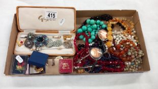 A large tray of costume jewellery including necklaces & brooches etc.
