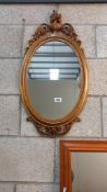 A gilt ormalu framed oval mirror COLLECT ONLY